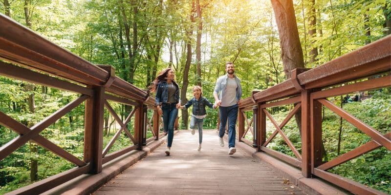 family-running-on-bridge