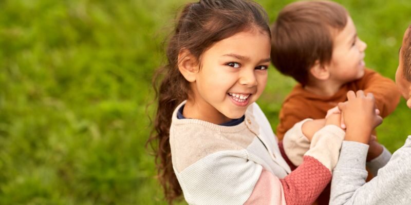 girl playing with friends outdoors