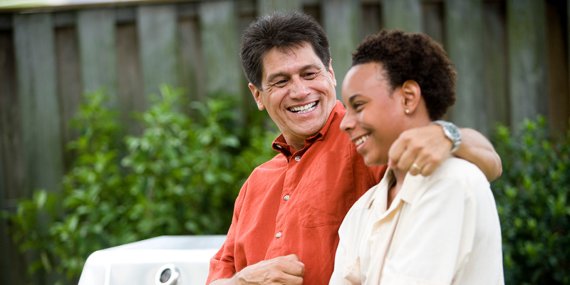 Adoptive father with arm around teenage son