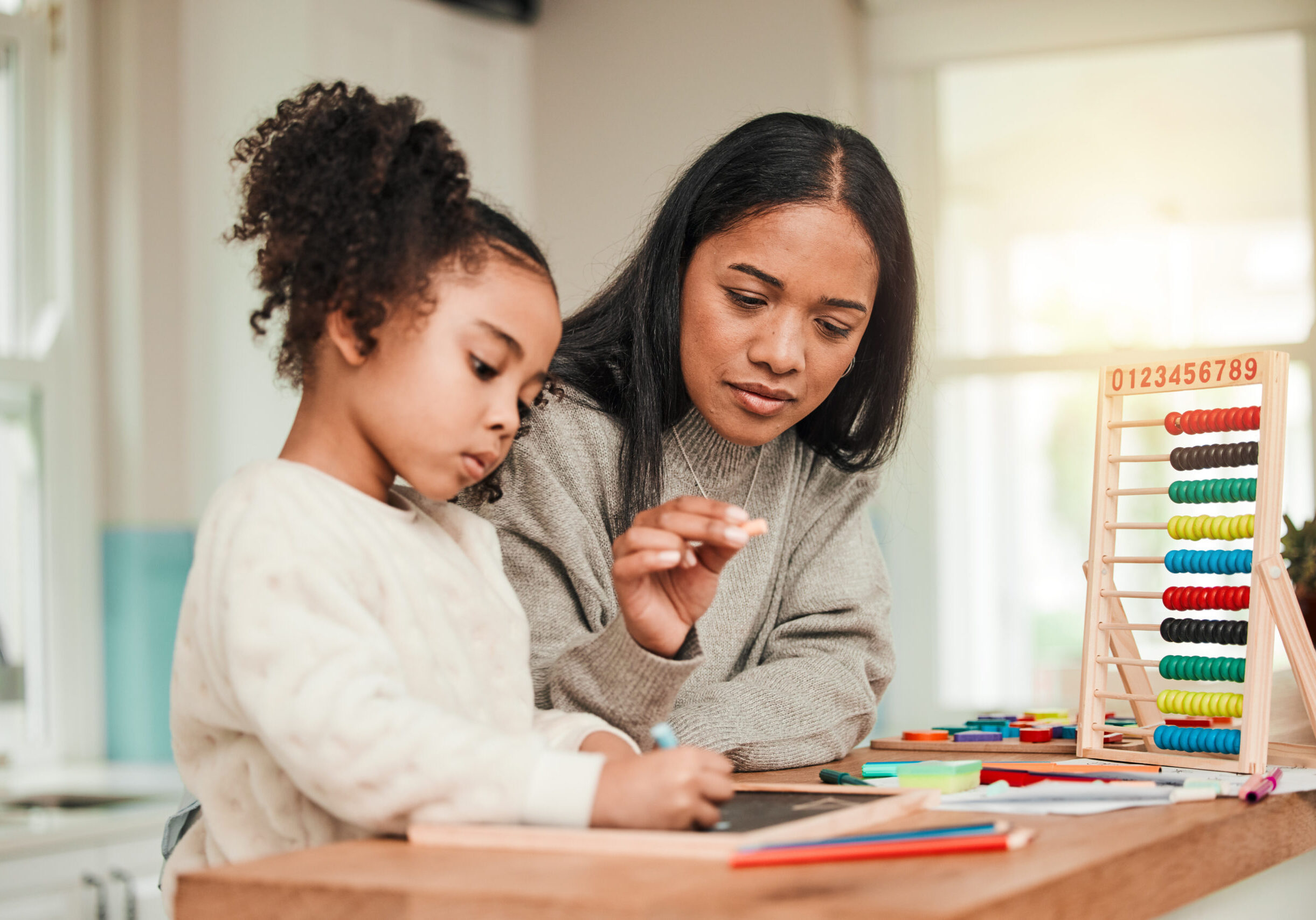 Learning, math and mother help kid with homework for homeschool lesson, project or academic assignment. Smile, happy and parent or mom support child with education, development and studying together.